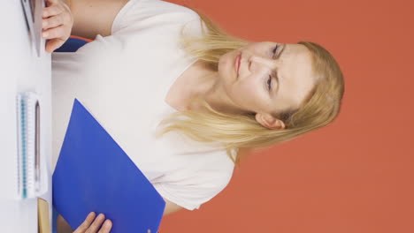 Vertical-video-of-The-woman-looking-at-the-documents-is-thoughtful.